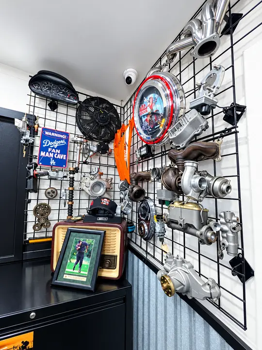 Wall of classic performance parts including turbochargers and chrome components at Cedillo's in Fullerton