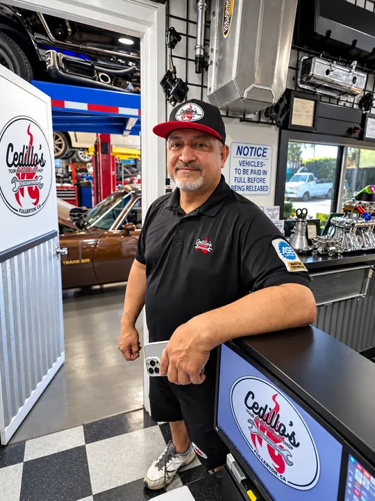 Rafael Cedillo, owner of Cedillo's Classic & Auto Repair, standing at the front counter in Fullerton