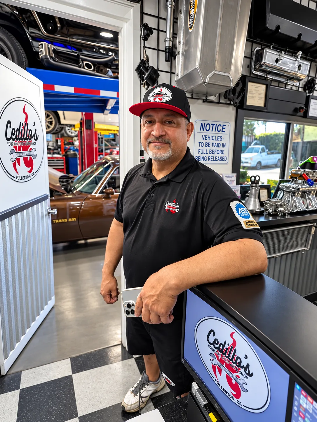 Rafael Cedillo, owner of Cedillo's Classic & Auto Repair, standing at the front counter in Fullerton
