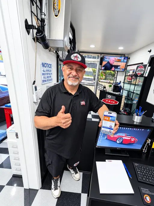Rafael Cedillo giving a thumbs-up at the front counter
